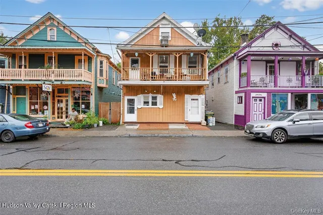 a front view of a residential apartment building with yard