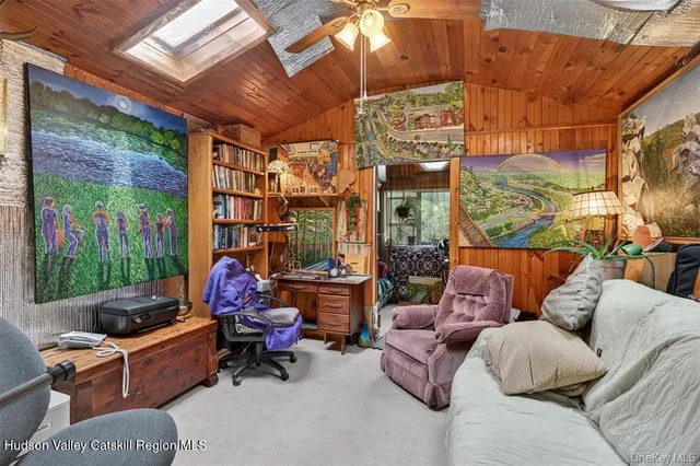 a bedroom with a bed dresser and a large window