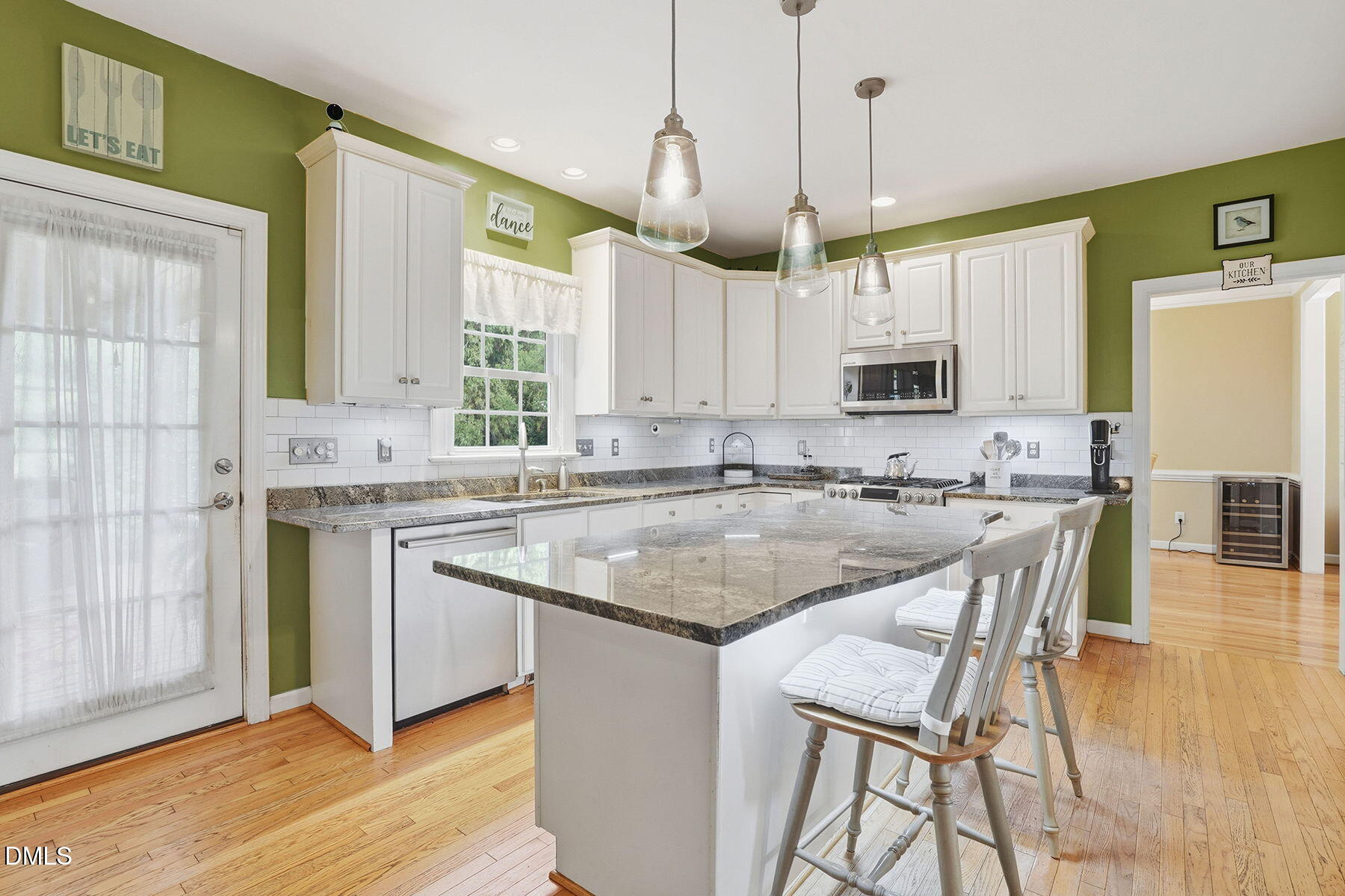 1012 Clatter Avenue Wake Forest, NC 27587 - Photo 13 of 34 a kitchen with stainless steel appliances granite countertop a sink a stove a refrigerator cabinets and a window