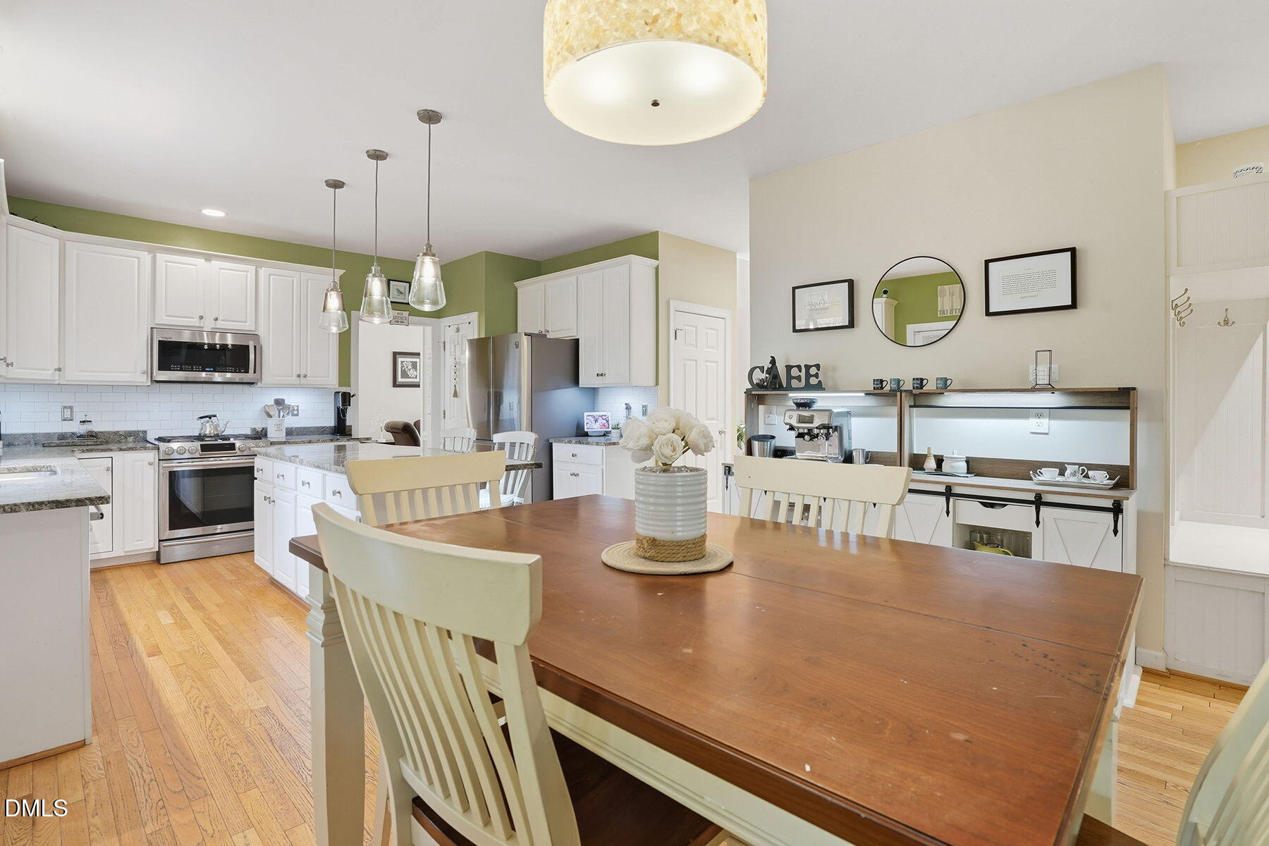 1012 Clatter Avenue Wake Forest, NC 27587 - Photo 15 of 34 a kitchen with stainless steel appliances granite countertop a stove a sink a microwave a center island and chairs