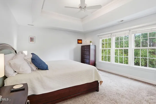 a bed sitting in a bedroom next to a window