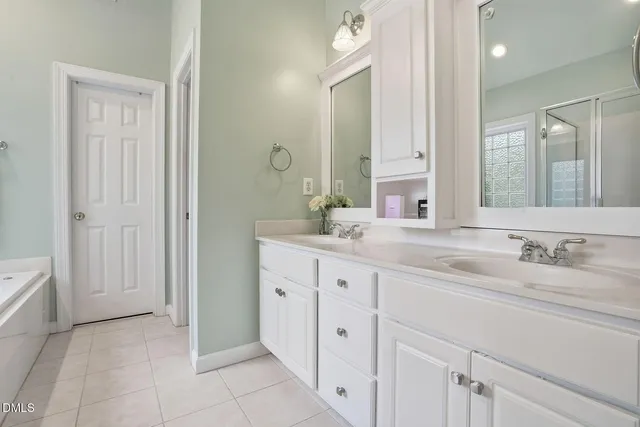 a bathroom with a double vanity sink and a mirror