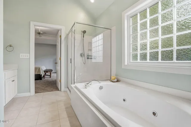 a bathroom with a tub next to a window