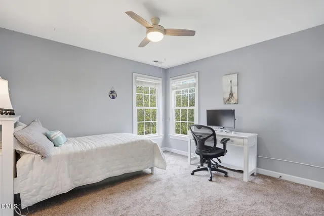 a view of a livingroom with workspace and a window