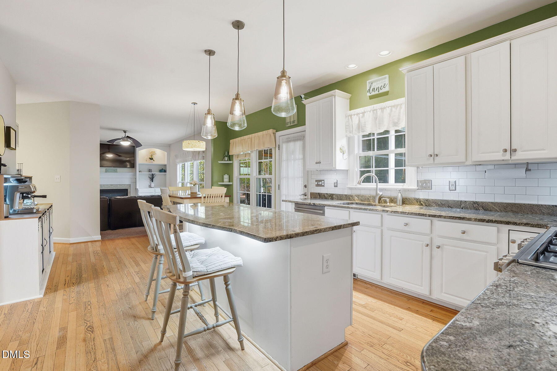 1012 Clatter Avenue Wake Forest, NC 27587 - Photo 4 of 34 a kitchen with granite countertop a stove a sink a dining table and chairs