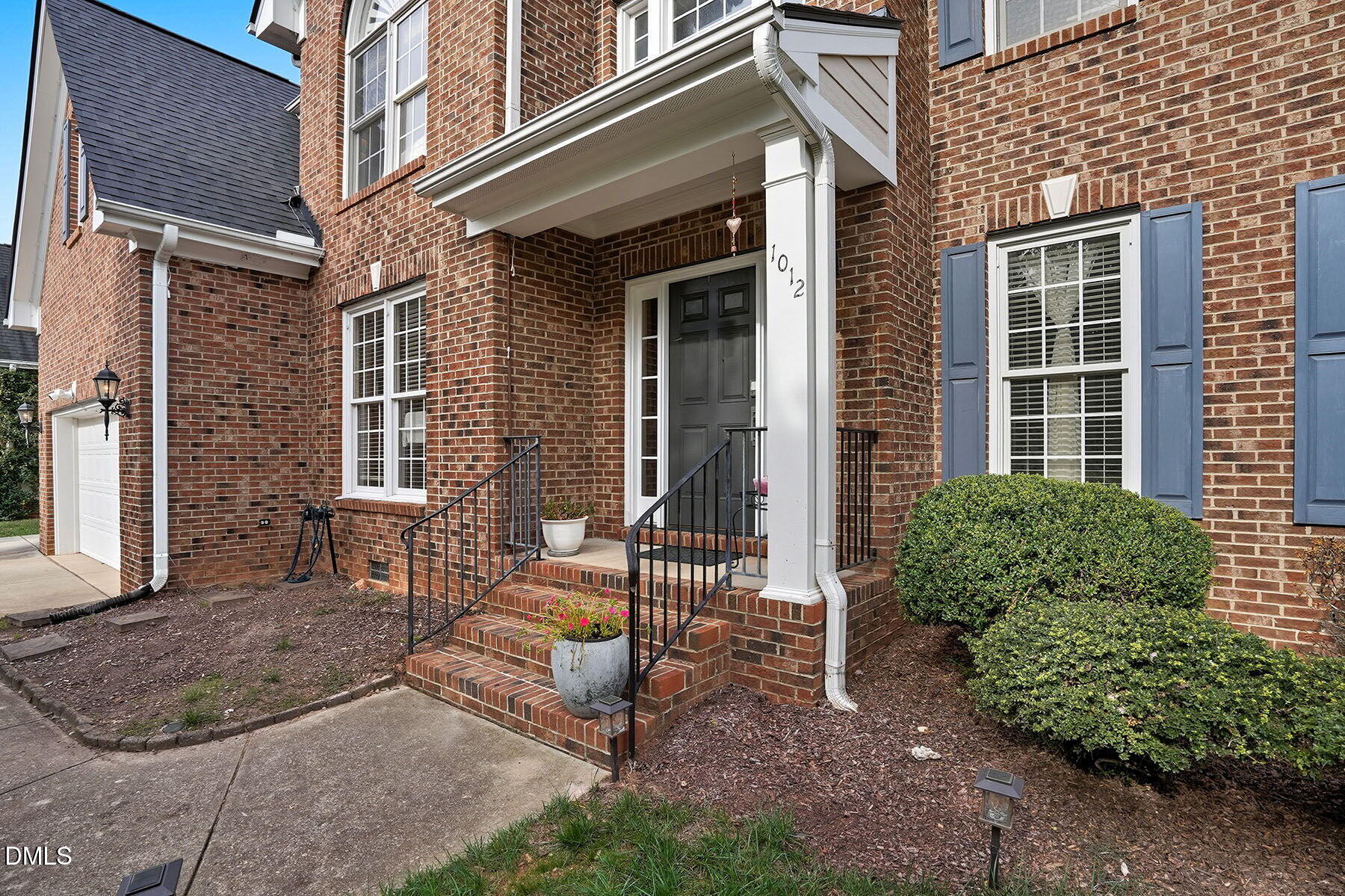 1012 Clatter Avenue Wake Forest, NC 27587 - Photo 8 of 34 a view of a brick house with a chairs and table in a patio