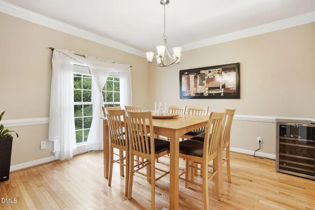 a view of a dining room with furniture wooden floor and chandelier