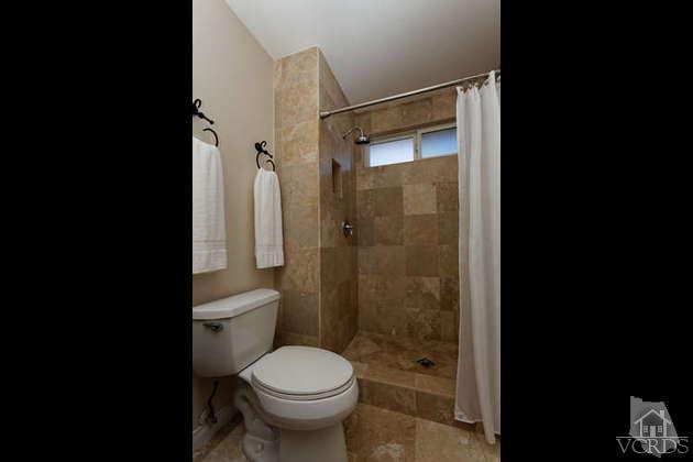 741 Appleton Road Simi Valley, CA 93065 - Photo 16 of 22 a bathroom with a granite countertop toilet a sink and shower