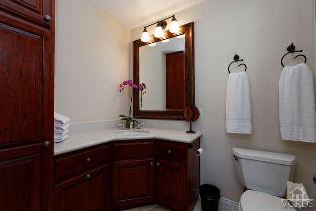 741 Appleton Road Simi Valley, CA 93065 - Photo 5 of 22 a bathroom with a granite countertop sink toilet and mirror