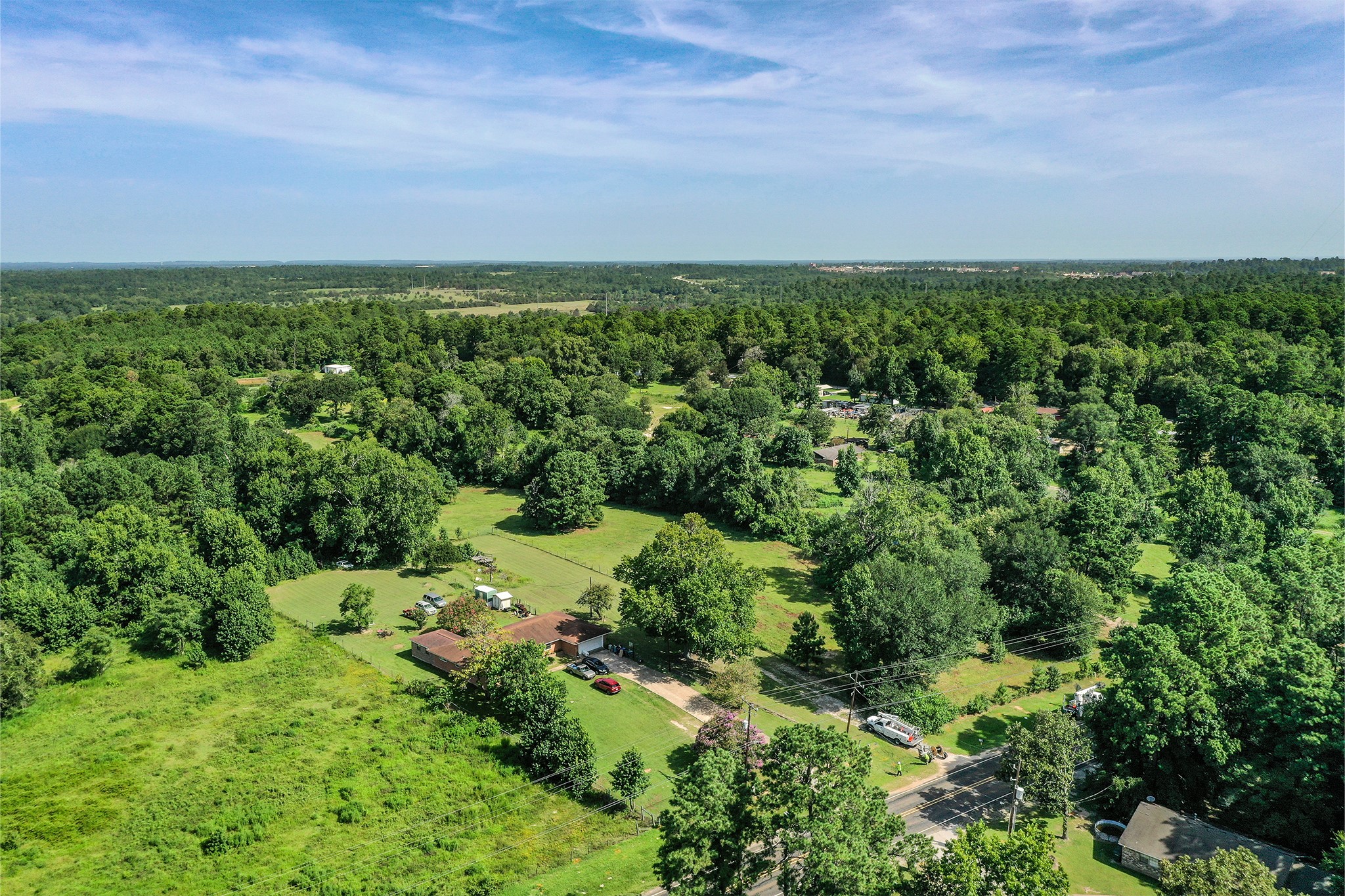 3722 Montgomery Road Huntsville, TX 77340 - Photo 2 of 16 an aerial view of a city with lots of residential buildings and mountain view in back