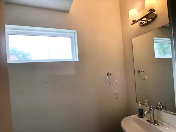 a bathroom with a sink toilet and mirror