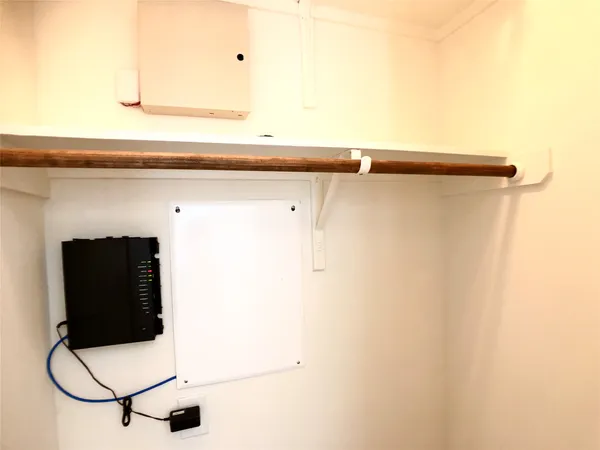 a white cabinet with a black white and white cabinet