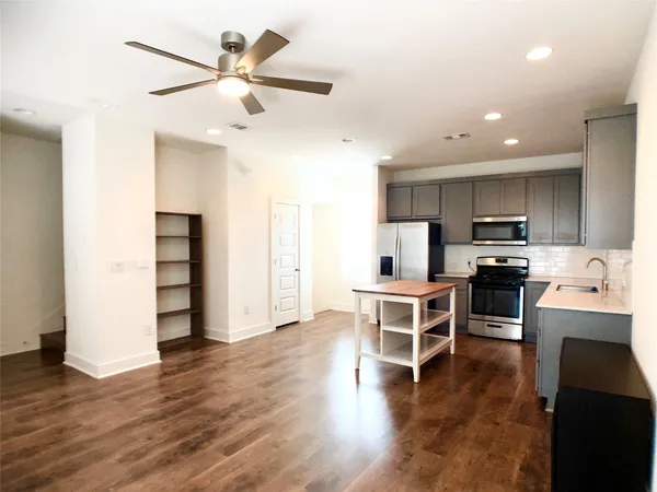 a view of kitchen with microwave and cabinets