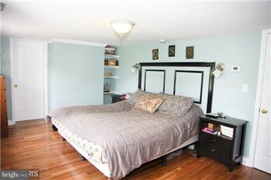 113 South Lightner Street Union Bridge, MD 21791 - Photo 12 of 20 a bedroom with a bed and a night stand