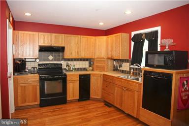 113 South Lightner Street Union Bridge, MD 21791 - Photo 7 of 20 a kitchen with stainless steel appliances granite countertop a stove top oven