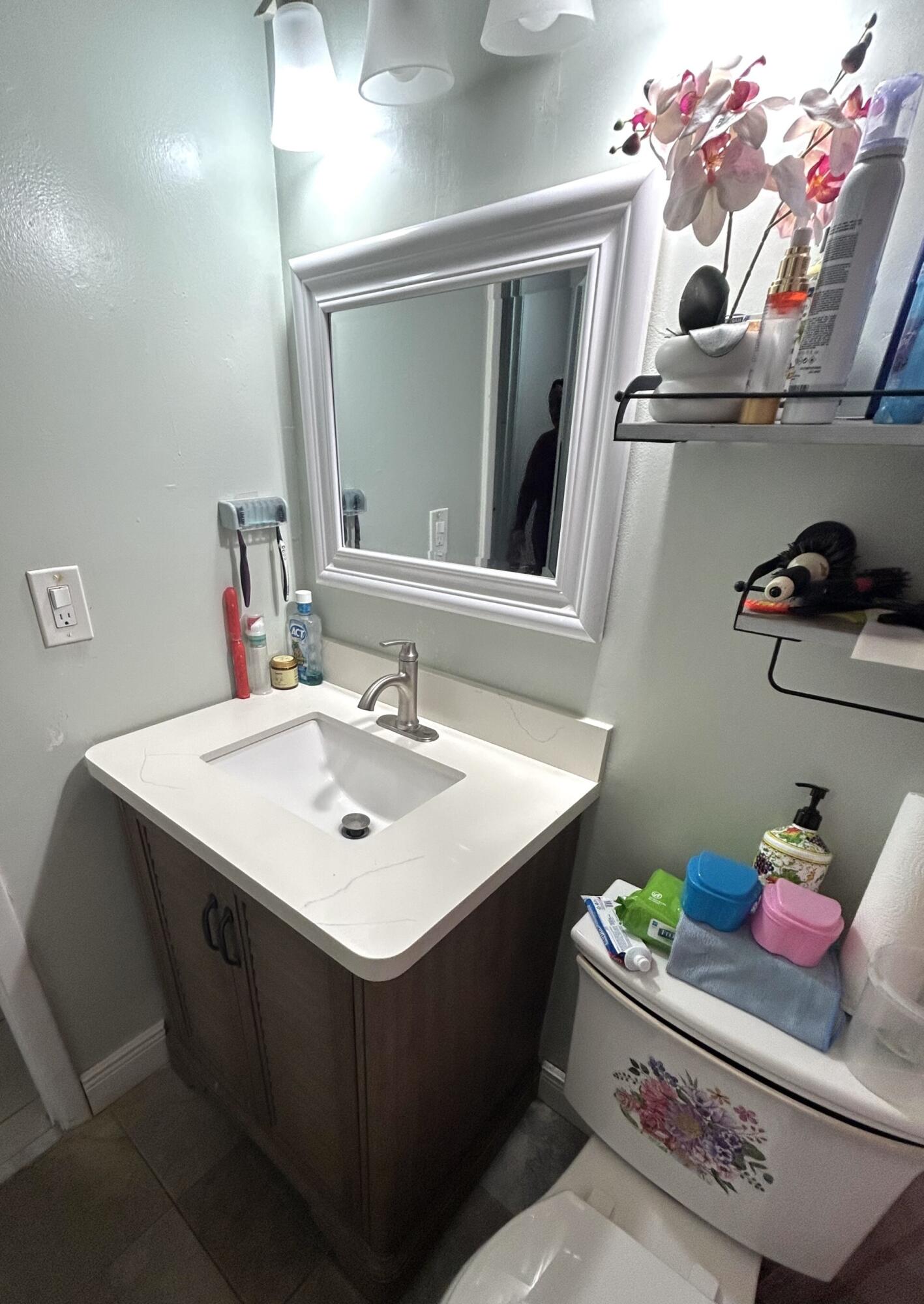 506 Davis Road, Unit 66 Palm Springs, FL 33461 - Photo 11 of 26 a bathroom with a sink vanity and mirror