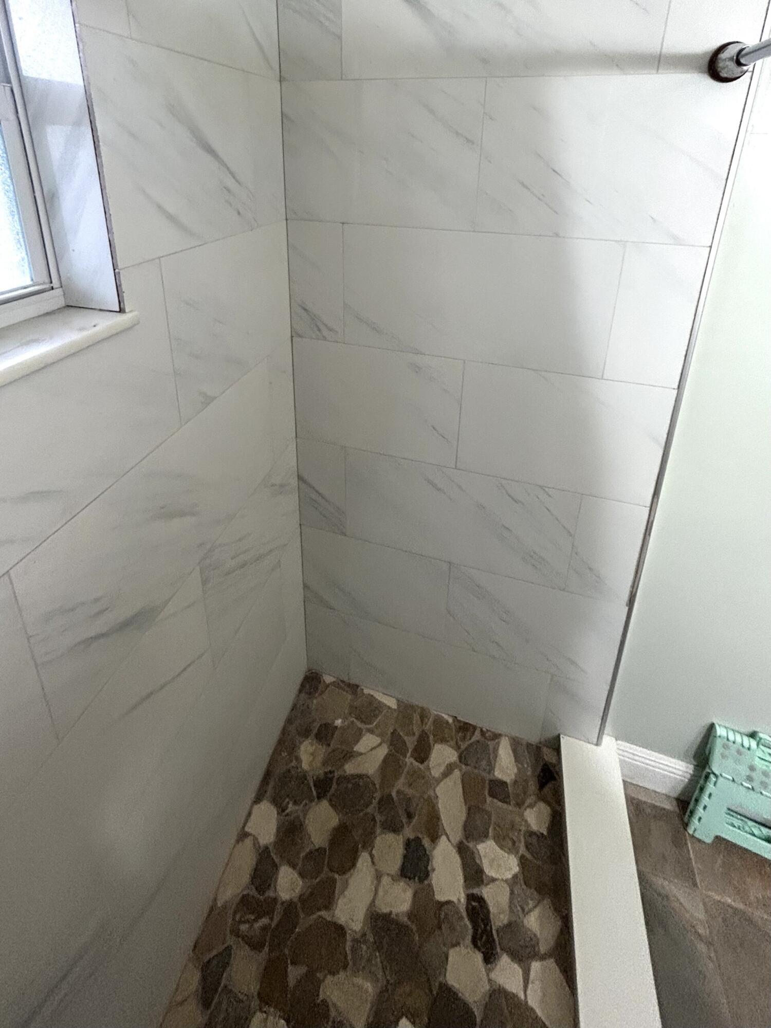 506 Davis Road, Unit 66 Palm Springs, FL 33461 - Photo 12 of 26 a bathroom with a bathtub and shower