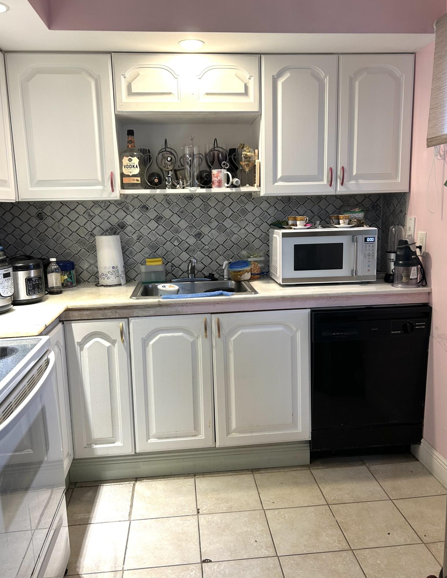 506 Davis Road, Unit 66 Palm Springs, FL 33461 - Photo 20 of 26 a kitchen with white cabinets