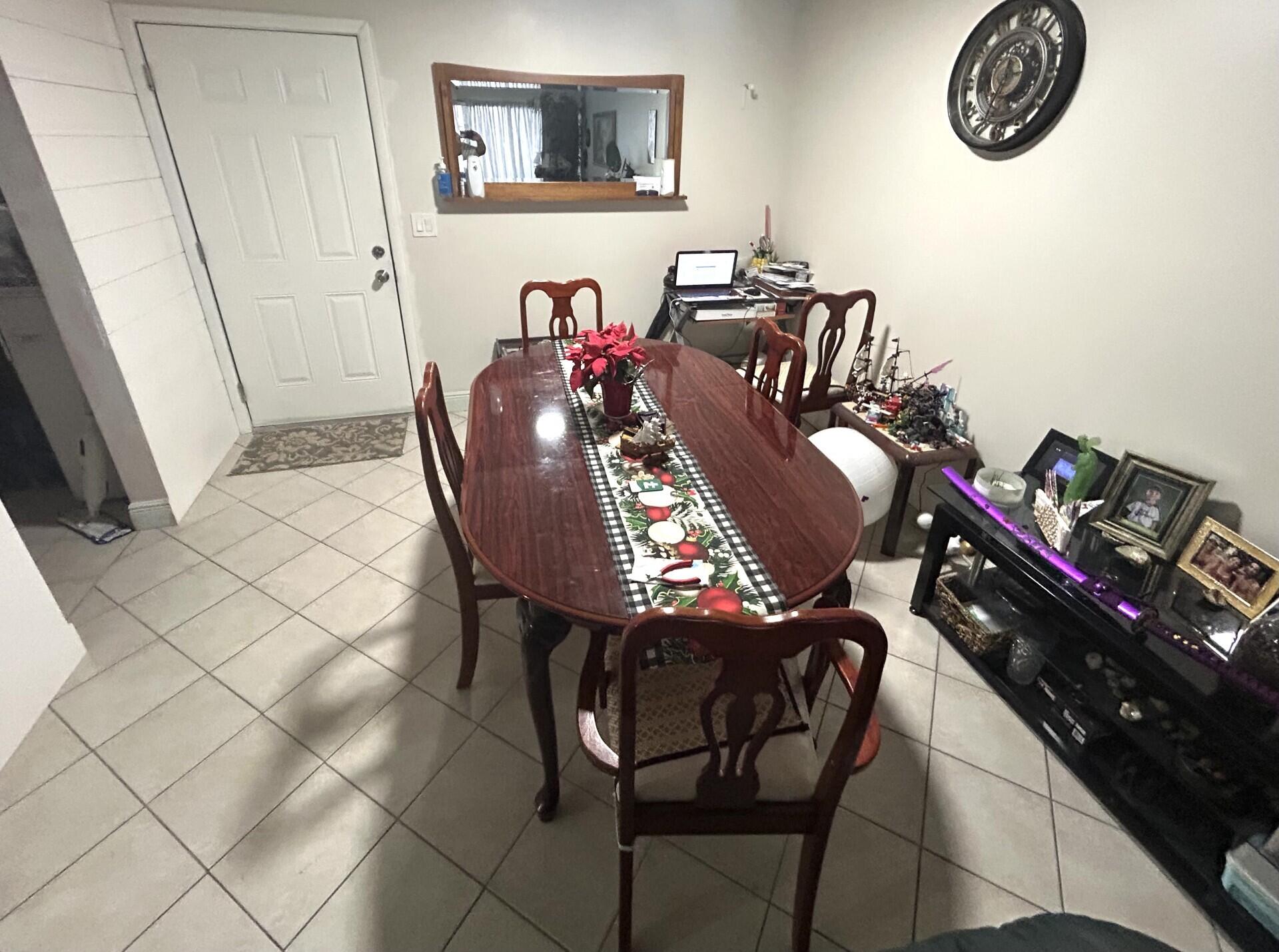 506 Davis Road, Unit 66 Palm Springs, FL 33461 - Photo 2 of 26 a view of a dining room with furniture and wooden floor