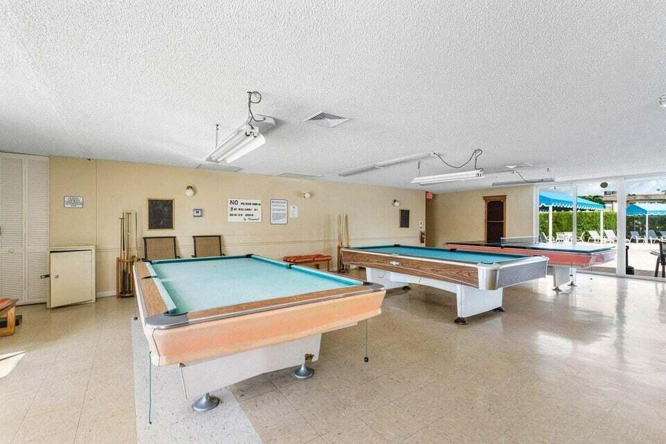 506 Davis Road, Unit 66 Palm Springs, FL 33461 - Photo 24 of 26 a room with pool table and windows