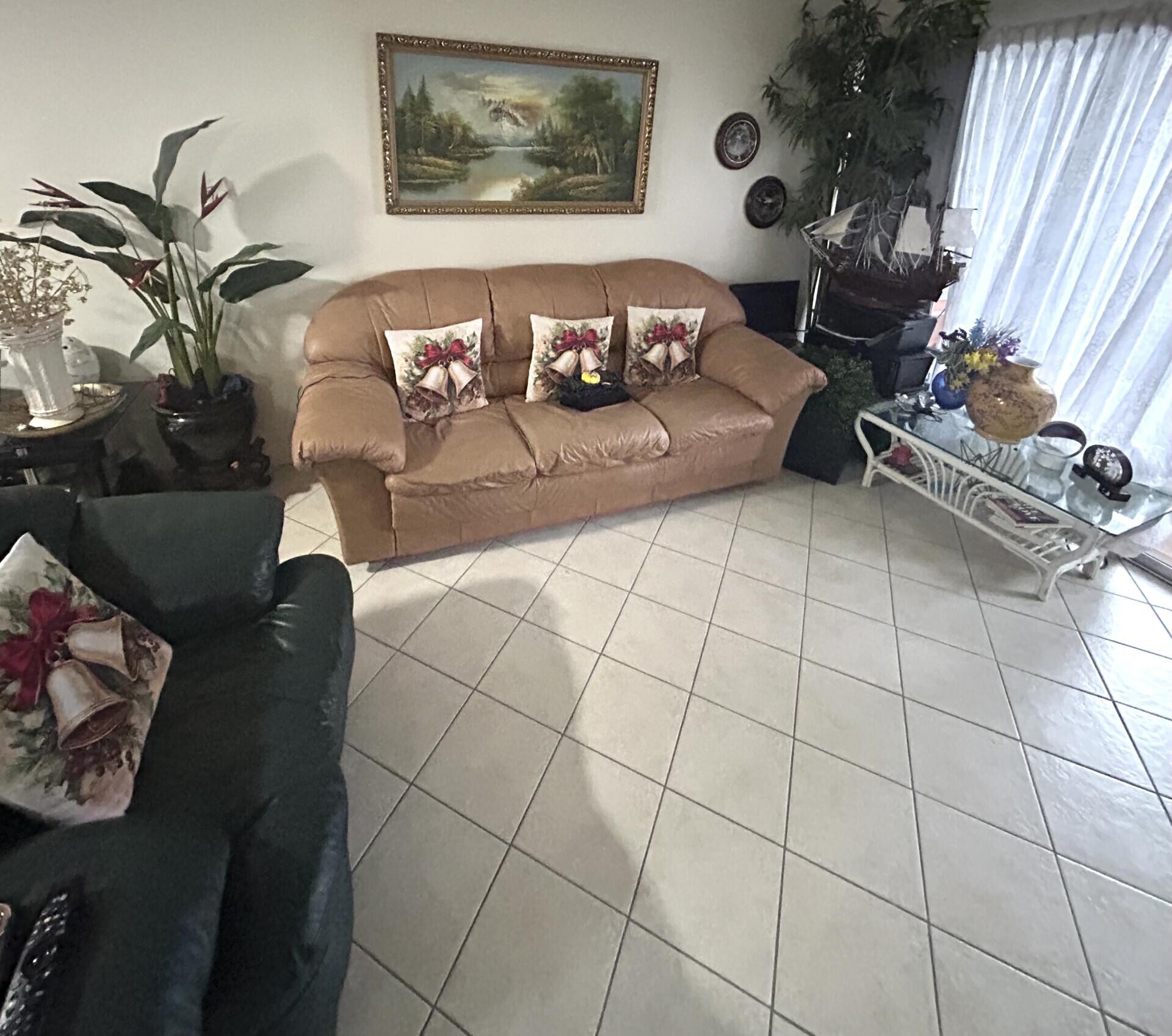 506 Davis Road, Unit 66 Palm Springs, FL 33461 - Photo 3 of 26 a living room with furniture and a floor to ceiling window