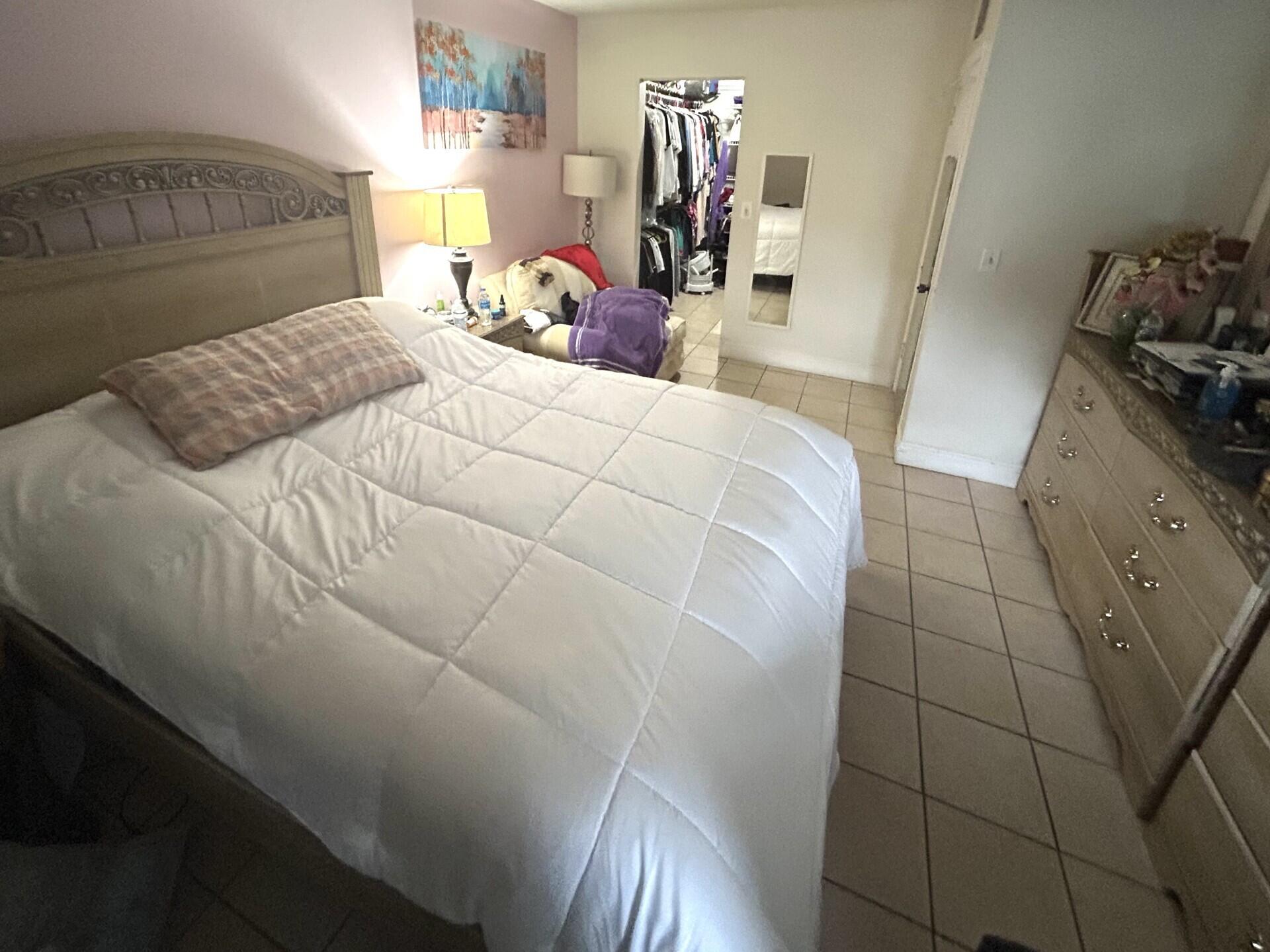 506 Davis Road, Unit 66 Palm Springs, FL 33461 - Photo 7 of 26 a bedroom with a bed and dresser