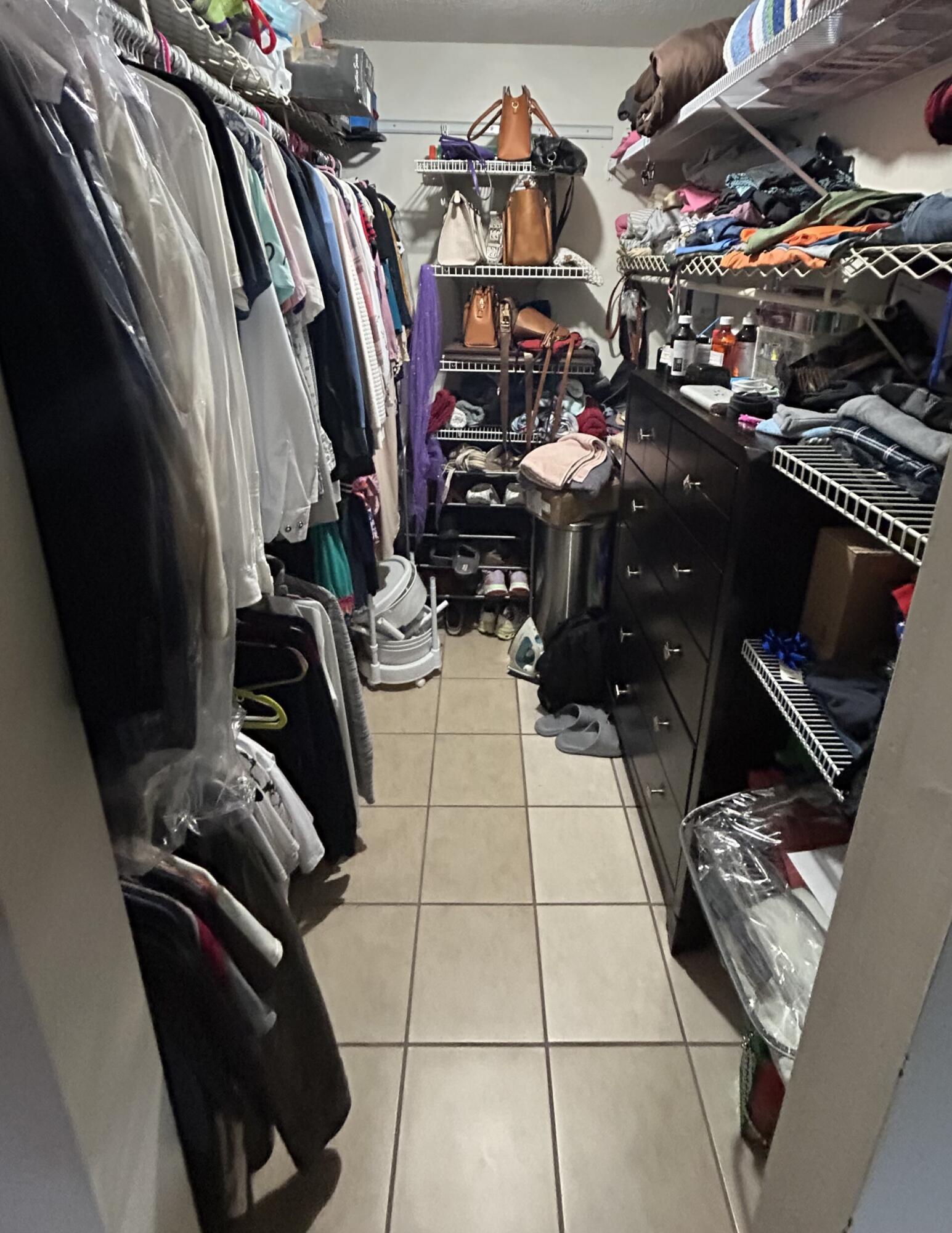 506 Davis Road, Unit 66 Palm Springs, FL 33461 - Photo 8 of 26 a view of walk in closet with clothes