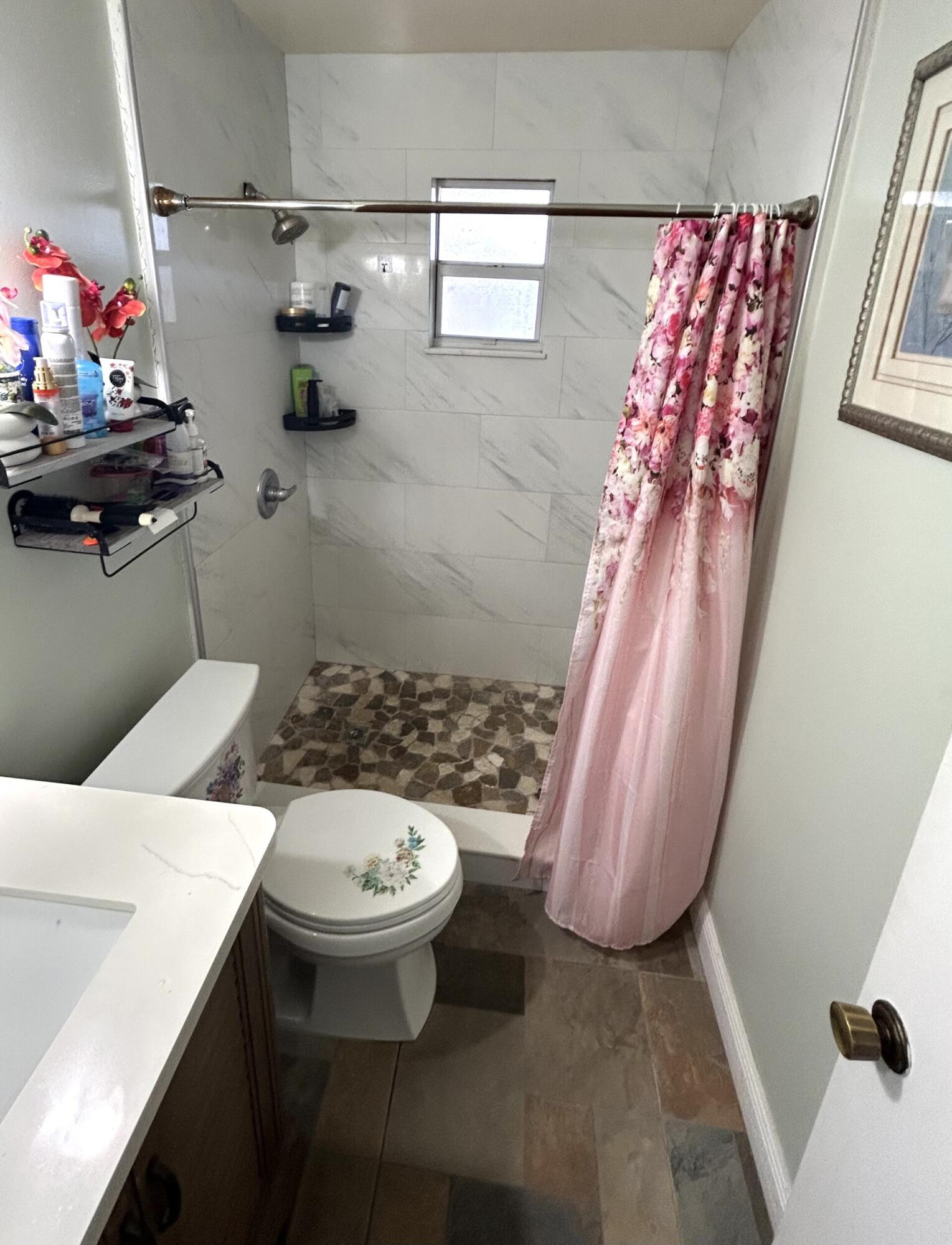 506 Davis Road, Unit 66 Palm Springs, FL 33461 - Photo 10 of 26 a bathroom with a sink a toilet and shower curtain