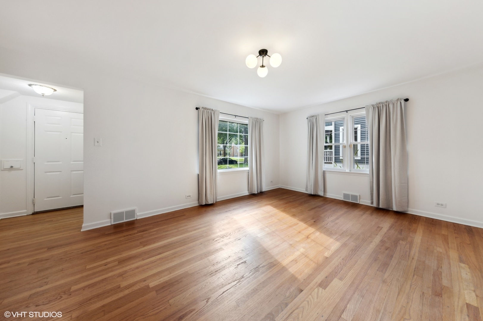 Undisclosed Address Western Springs, IL 60558 - Photo 2 of 15 an empty room with wooden floor and windows