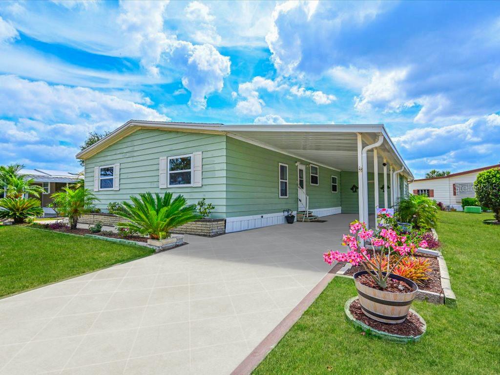a front view of a house with a big yard