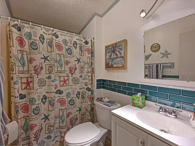 a bathroom with a sink toilet and a mirror