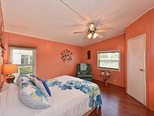 a bedroom with a bed dresser and a chair