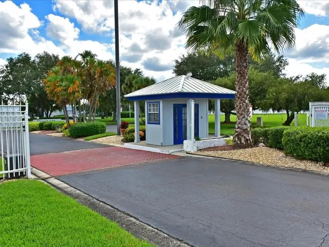 a view of a house with a yard and large tree