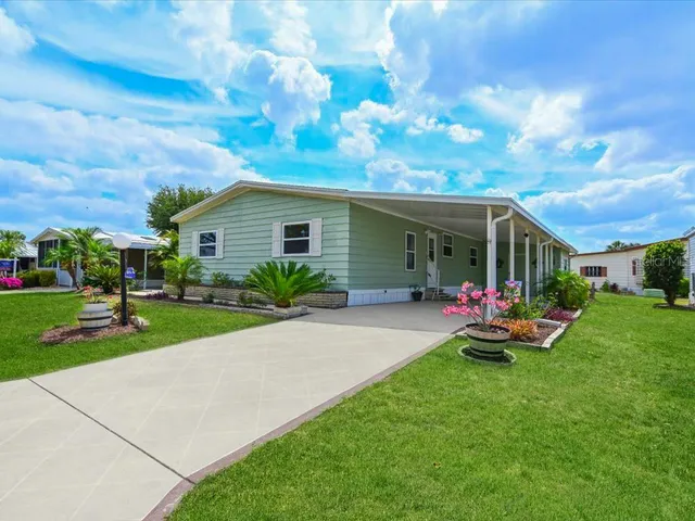 a view of a house with backyard sitting area and garden