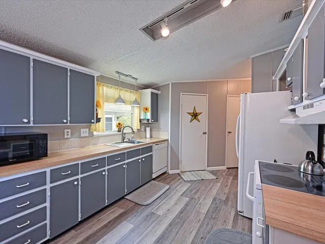 a view of a kitchen counter space and windows