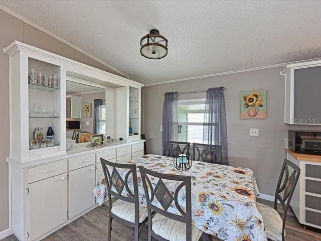 a view of a a dining room with furniture window and wooden floor