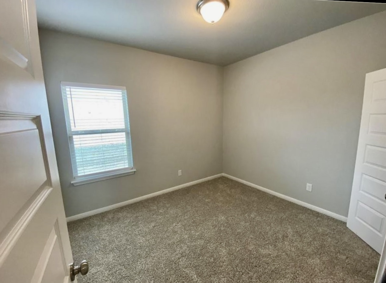 119 Wild Wind Cove Jarrell, TX 76537 - Photo 11 of 16 Carpeted spare room featuring baseboards