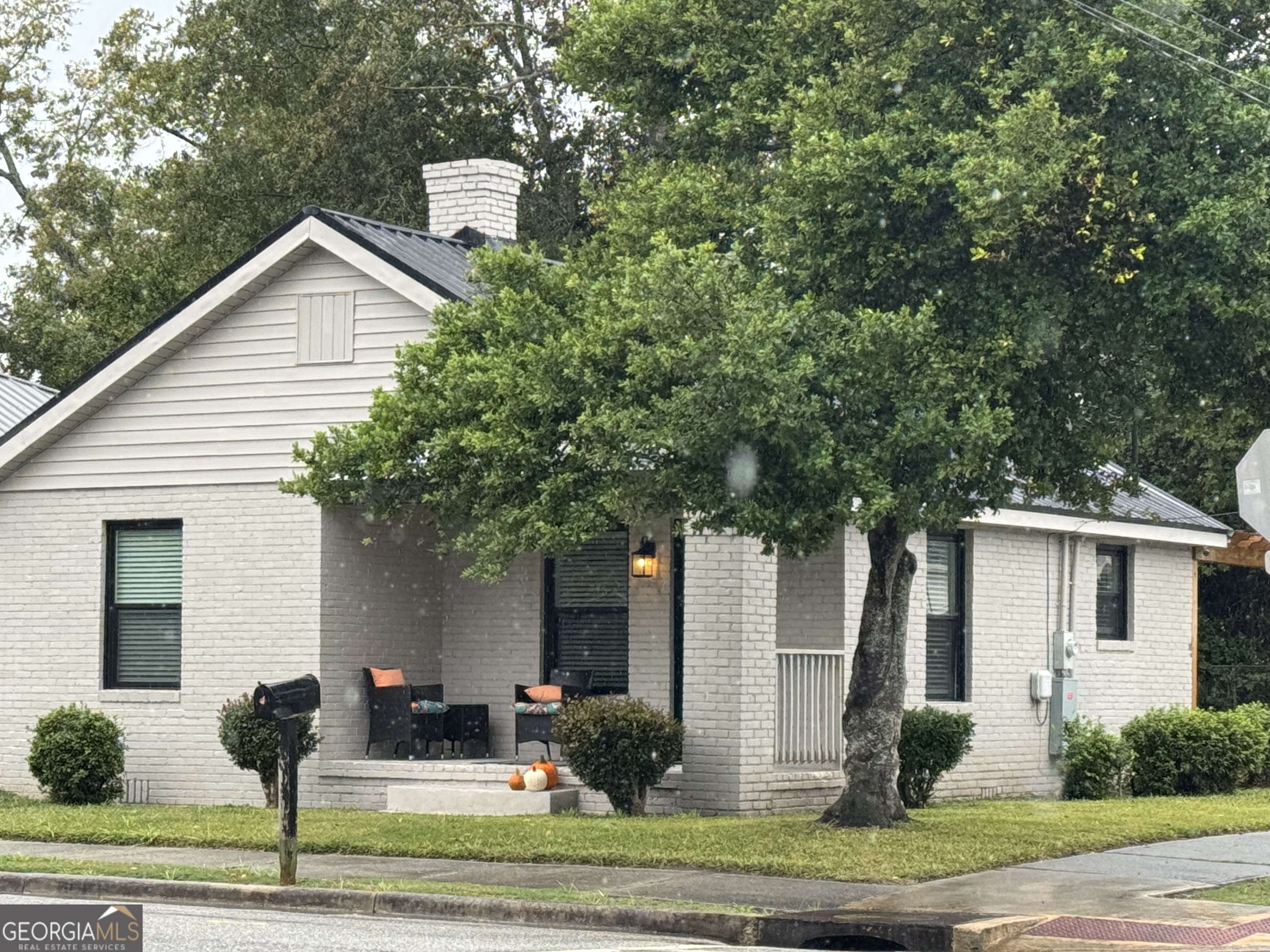 339 North Gray Street Millen, GA 30442 - Photo 1 of 16 a front view of a house with garden and plants