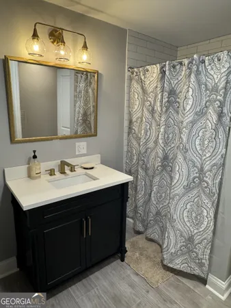 a bathroom with a sink vanity and a mirror