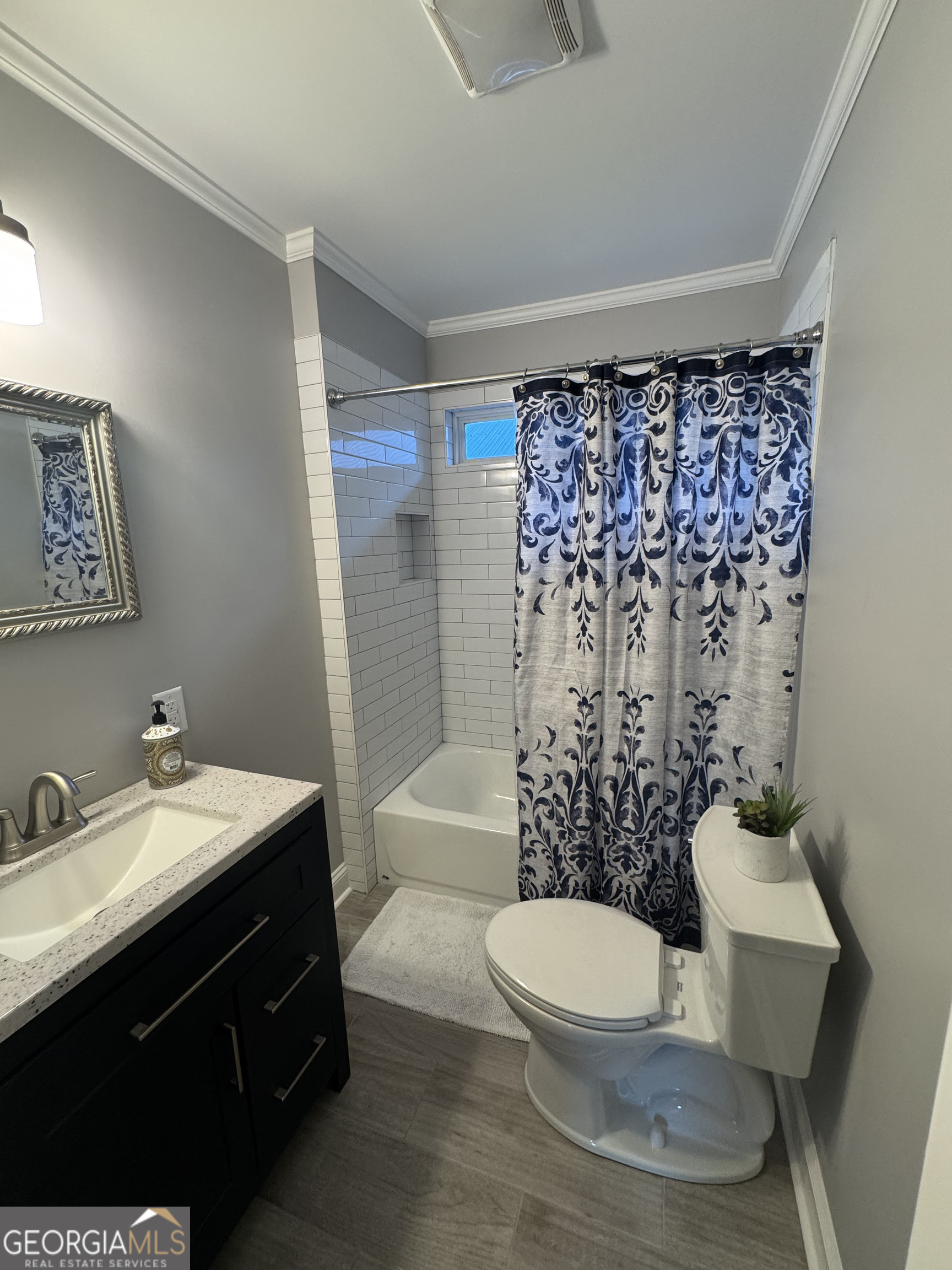 339 North Gray Street Millen, GA 30442 - Photo 8 of 16 a bathroom with a sink toilet and shower