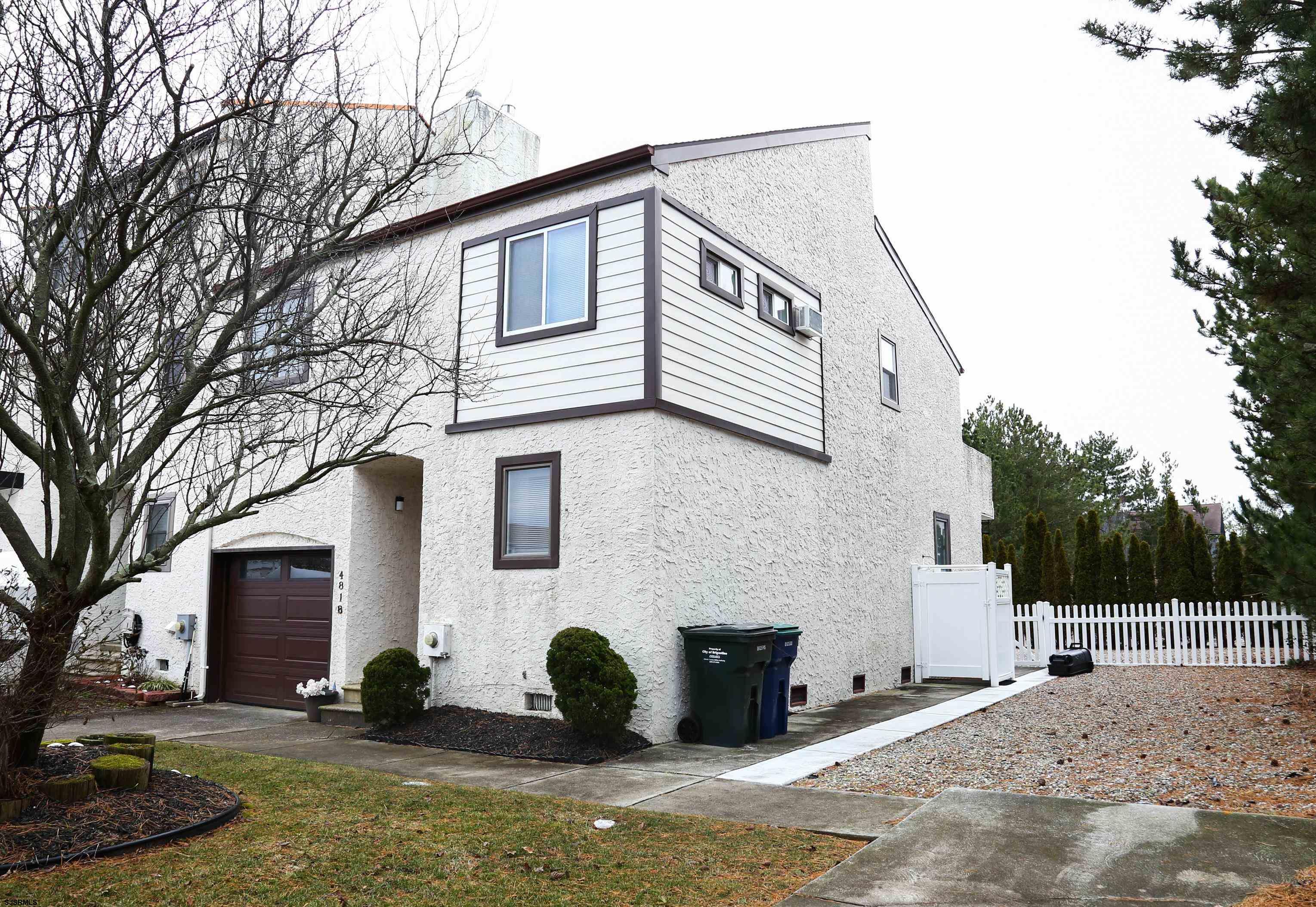 4818 Harbor Beach Boulevard Brigantine, NJ 08203 - Photo 5 of 30 a view of a white house with a large tree
