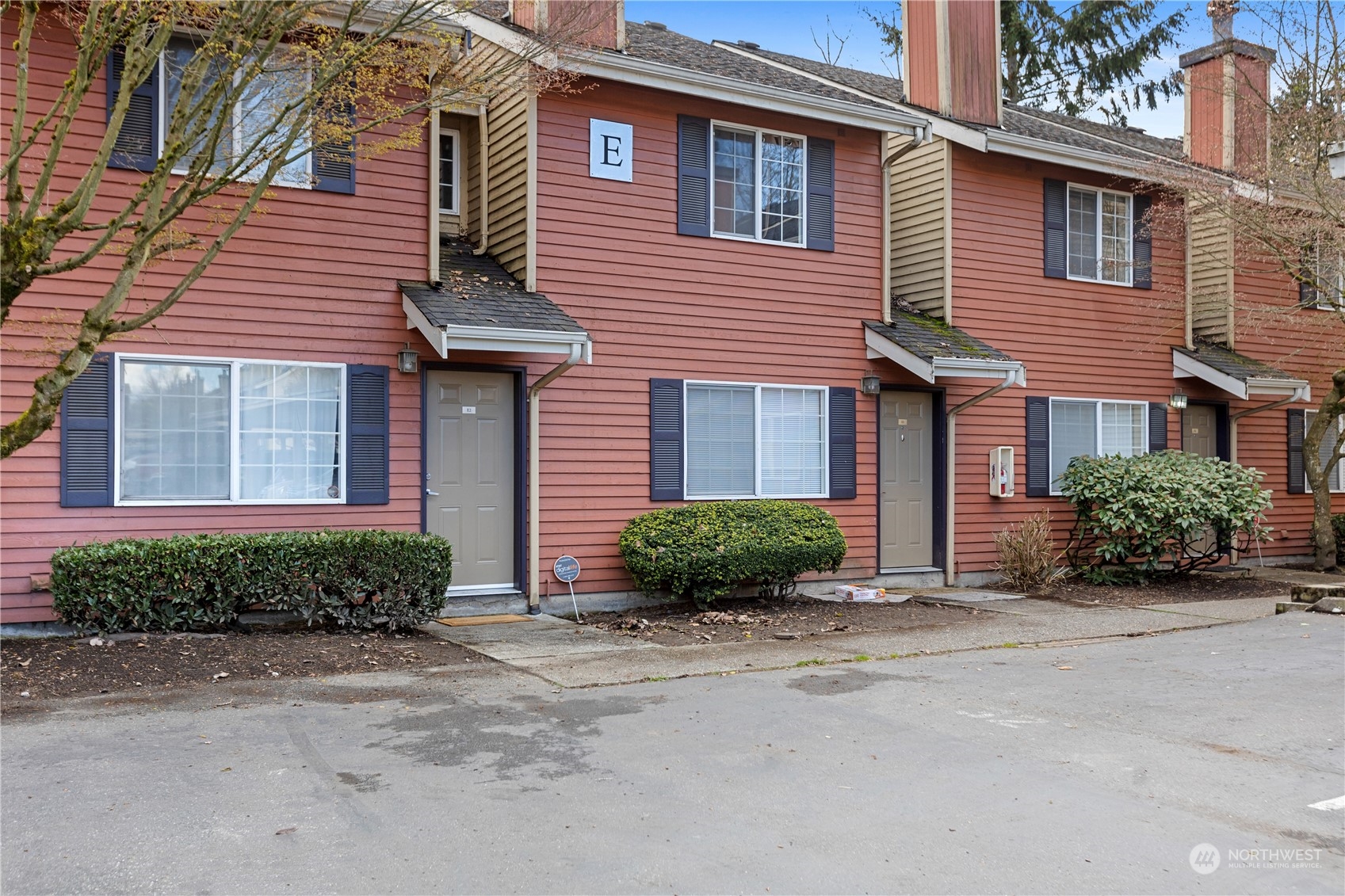 412 Center Road, Unit E2 Everett, WA 98204 - Photo 1 of 18 a front view of a house with a garden