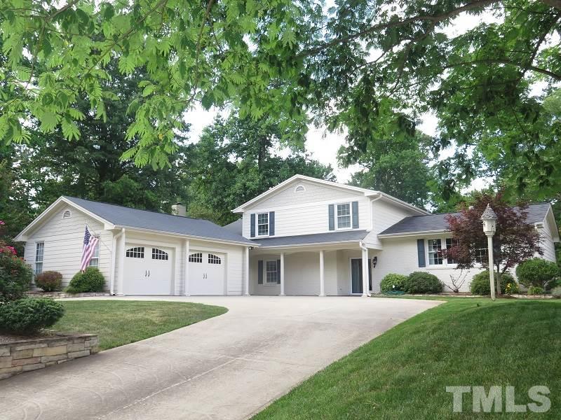 7617 Harps Mill Road Raleigh, NC 27615 - Photo 1 of 24 a front view of a house with a yard and garage