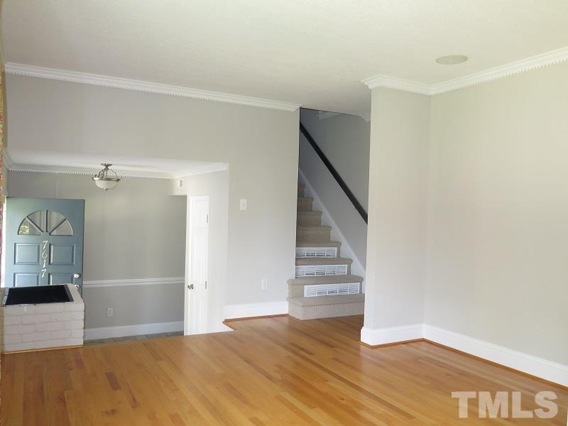 7617 Harps Mill Road Raleigh, NC 27615 - Photo 2 of 24 a view of an empty room with wooden floor and entryway