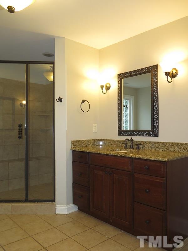 7617 Harps Mill Road Raleigh, NC 27615 - Photo 11 of 24 a bathroom with a granite countertop sink and a mirror
