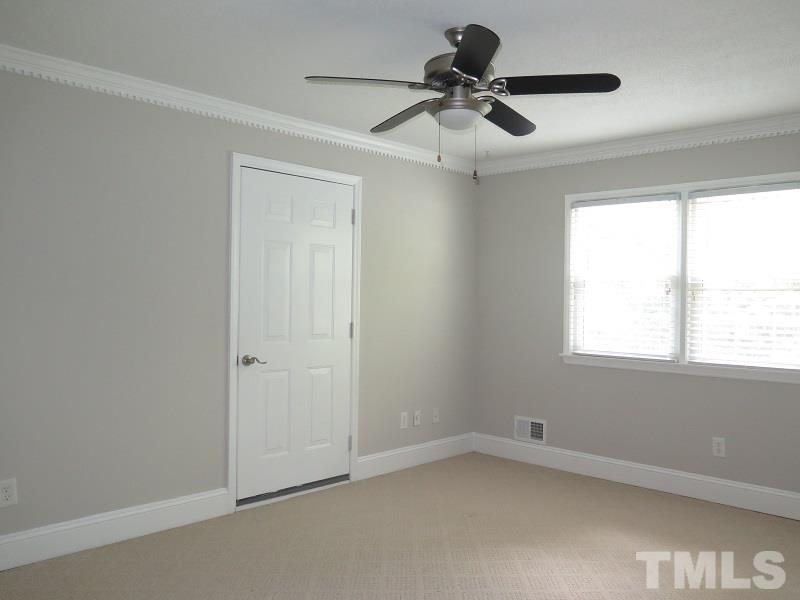 7617 Harps Mill Road Raleigh, NC 27615 - Photo 15 of 24 wooden floor in an empty room with a window