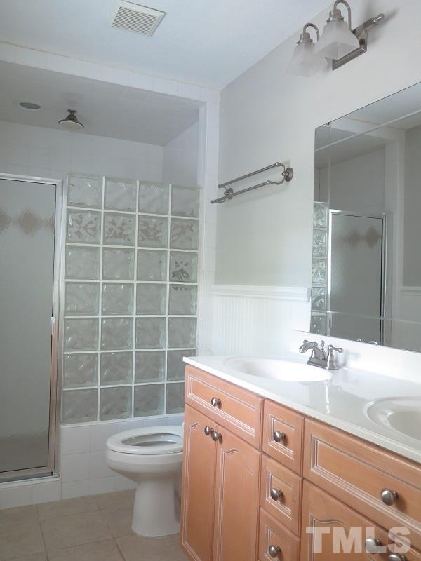 7617 Harps Mill Road Raleigh, NC 27615 - Photo 16 of 24 a bathroom with a sink a toilet and shower