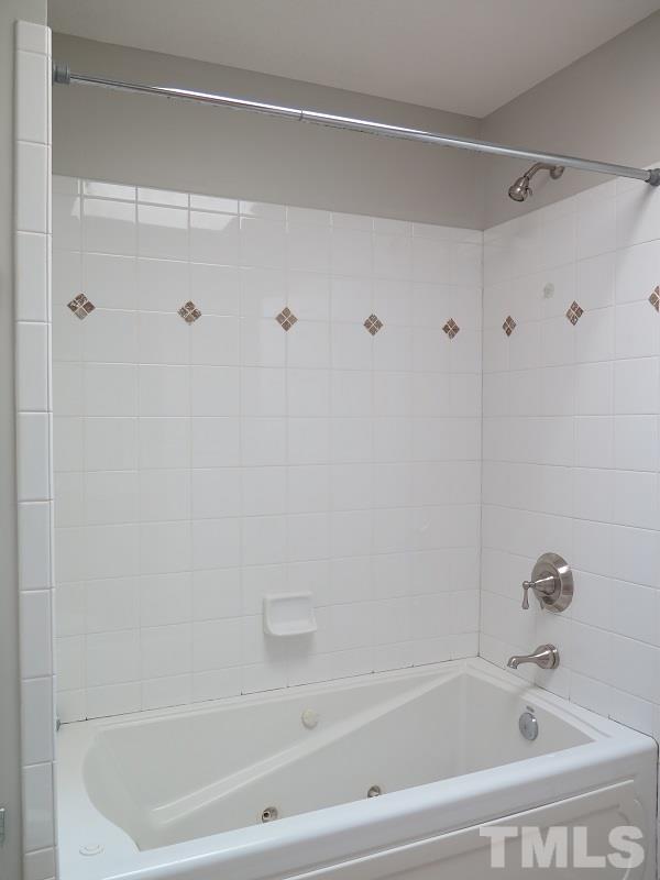 7617 Harps Mill Road Raleigh, NC 27615 - Photo 18 of 24 a bathroom with a bathtub