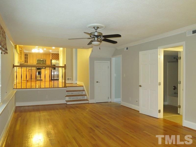 7617 Harps Mill Road Raleigh, NC 27615 - Photo 5 of 24 a view of an empty room with window and wooden floor