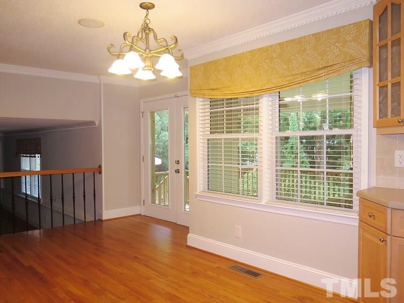 7617 Harps Mill Road Raleigh, NC 27615 - Photo 7 of 24 a view of livingroom with wooden floor and windows